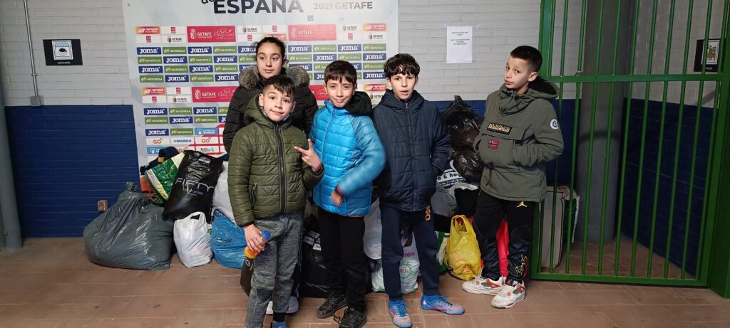 Niños y niñas con las bolsas entregadas de ropa