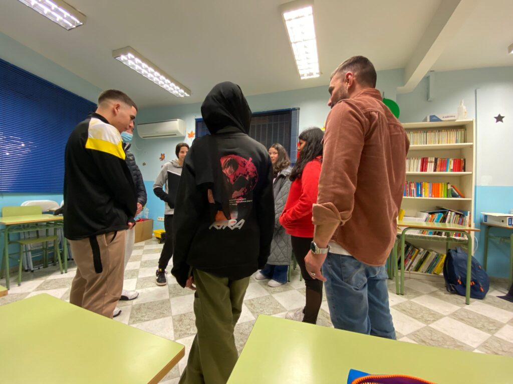 Chicos y chicas en medio de un aula haciendo un círculo